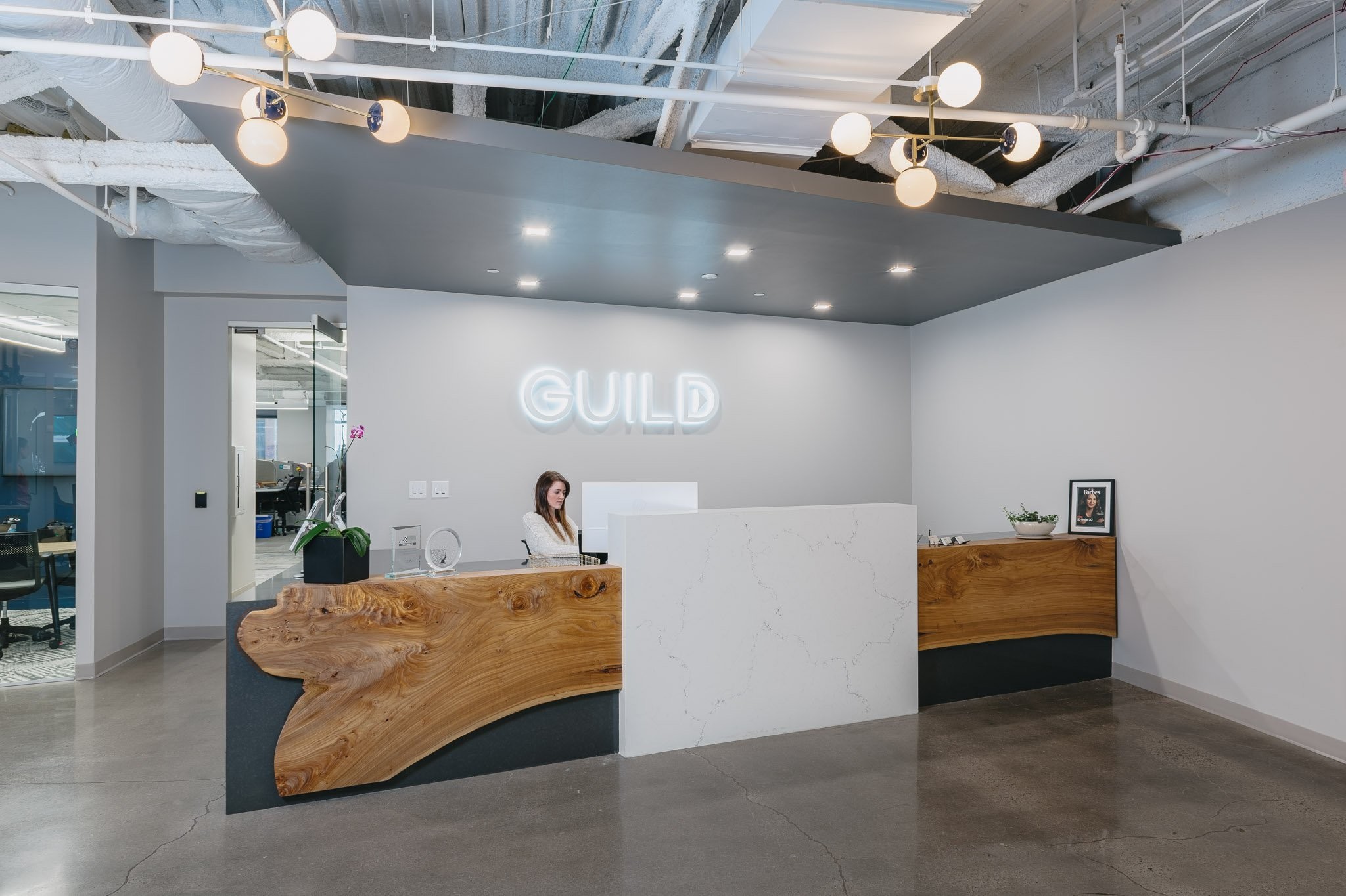 Guild employee sitting at the front desk of their office