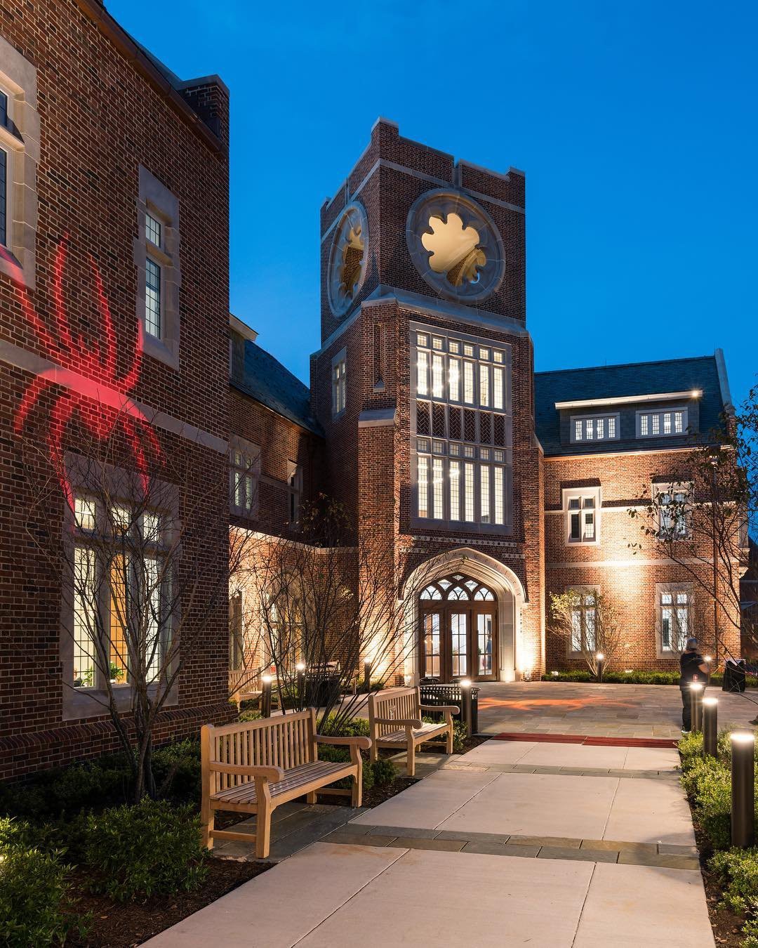 University of Richmond campus building at night with a spider logo