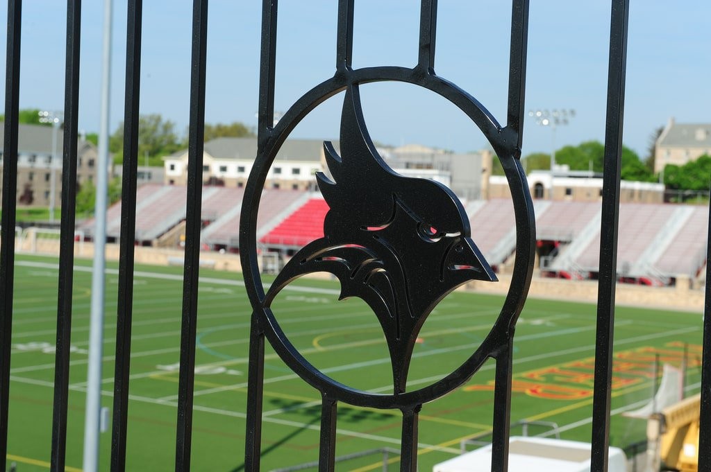 Image of a metal bird on a stadium gate on campus