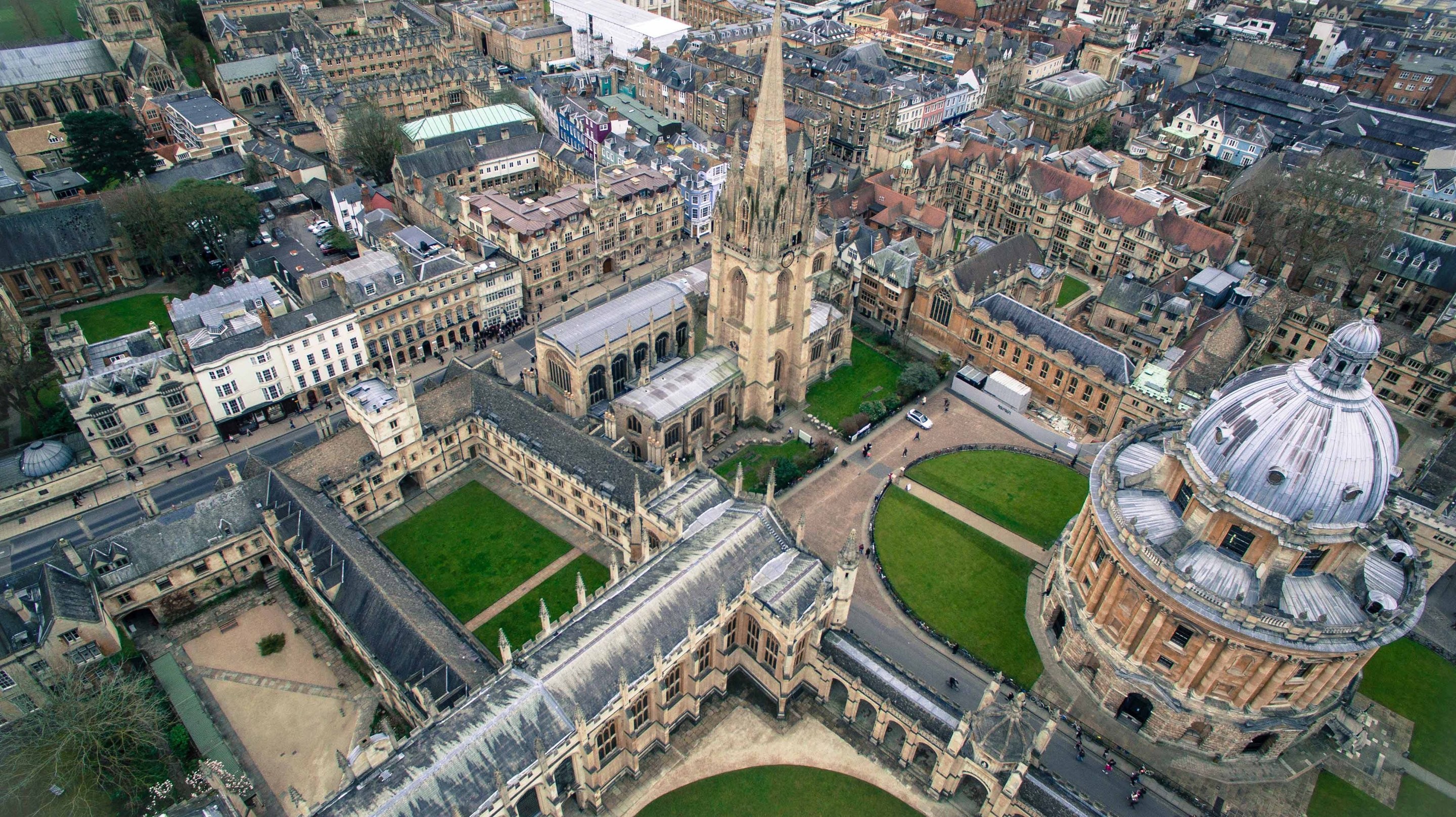 An aerial view of Oxford University's Radcliffe Square showing the dome and steeple structures and other campus buildings
