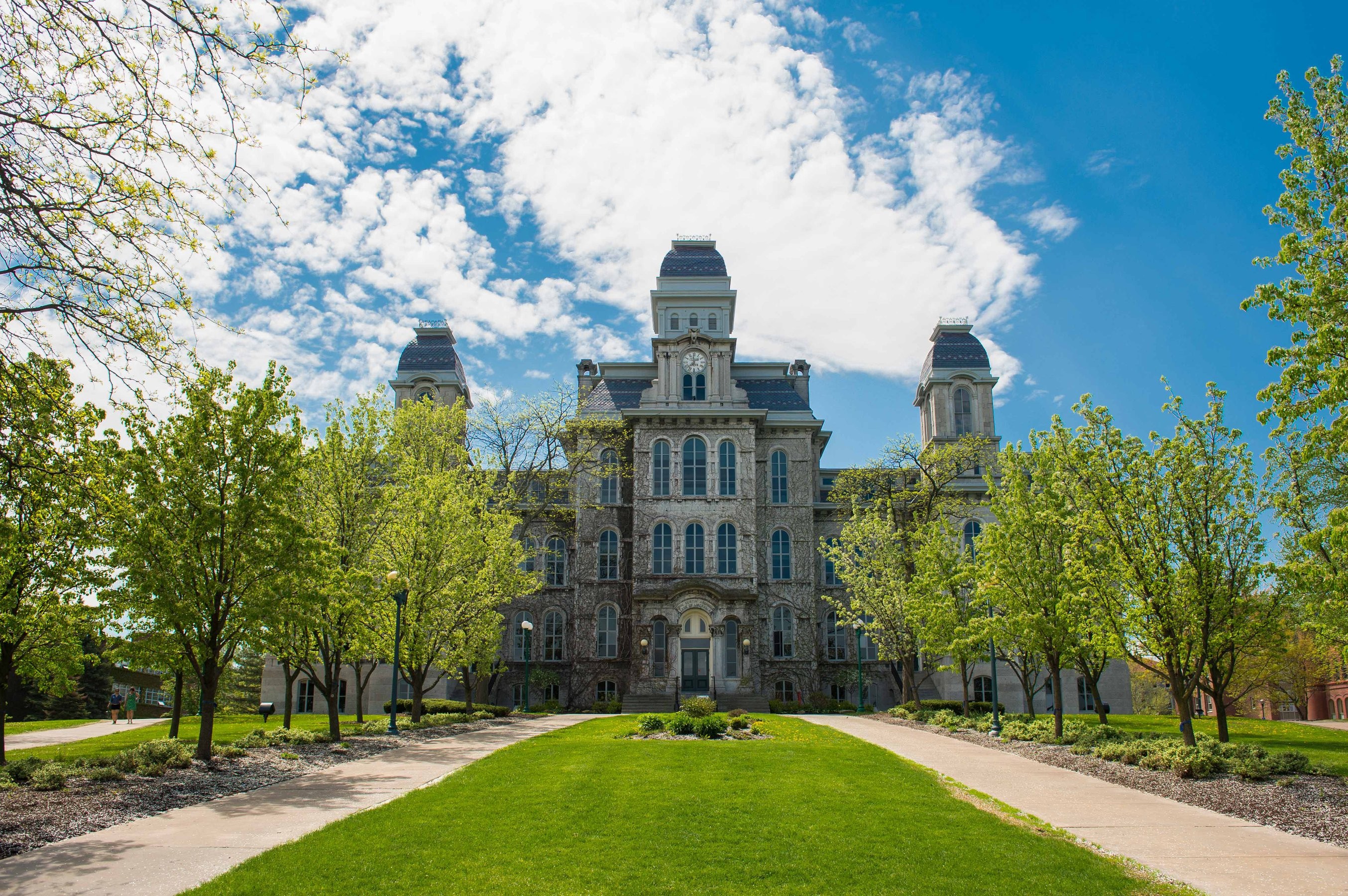 Hall of Languages building at Syracuse University with trees and grass lining the front entrance