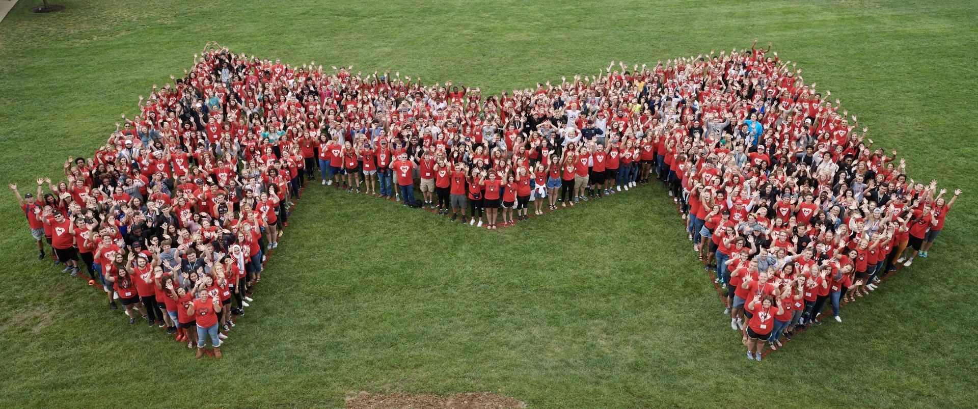 Image of students standing in the formation of a large 'M' on the grass at Maryville University