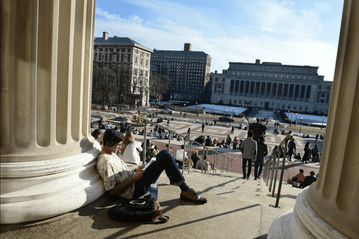 Students sitting outside on the campus of Columbia University